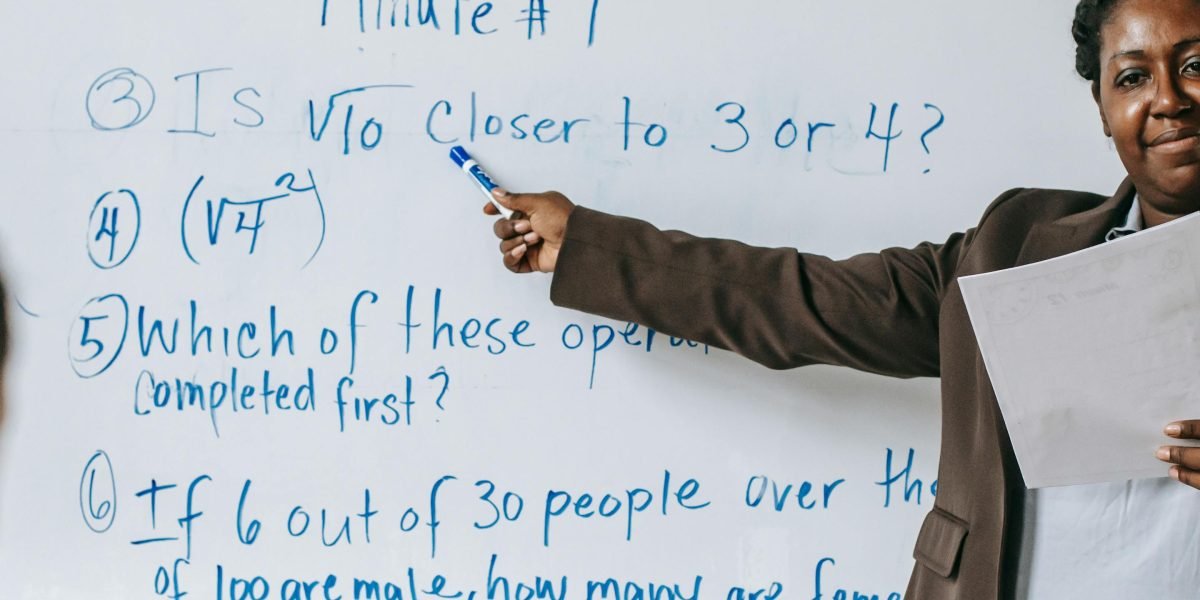 A teacher helps a student work through a problem, highlighting the need for accurate information.