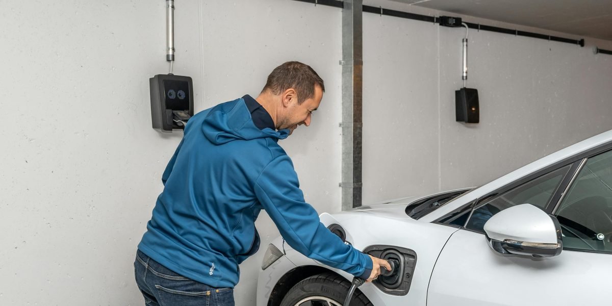 A driver looking frustrated at a non-operational or full EV charging station, encapsulating the real-world impact of inaccurate AI predictions.