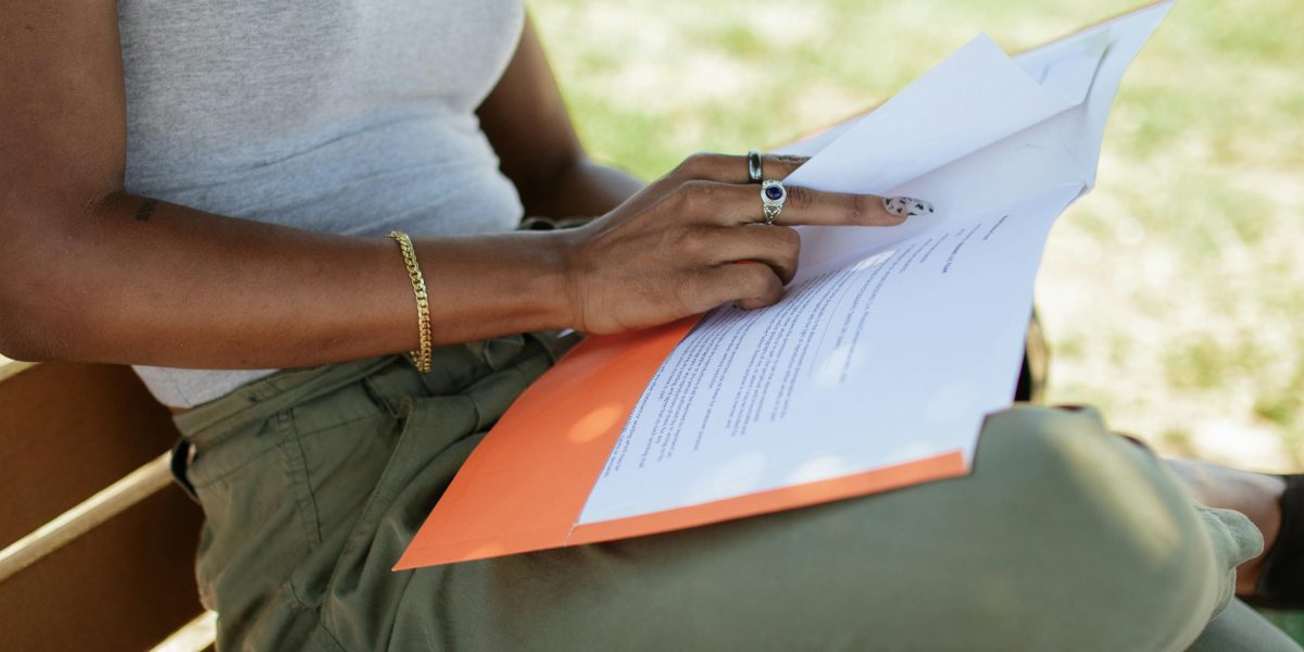 A person intently reviewing documents, symbolizing the critical thinking needed to discern accurate information in the age of AI.
