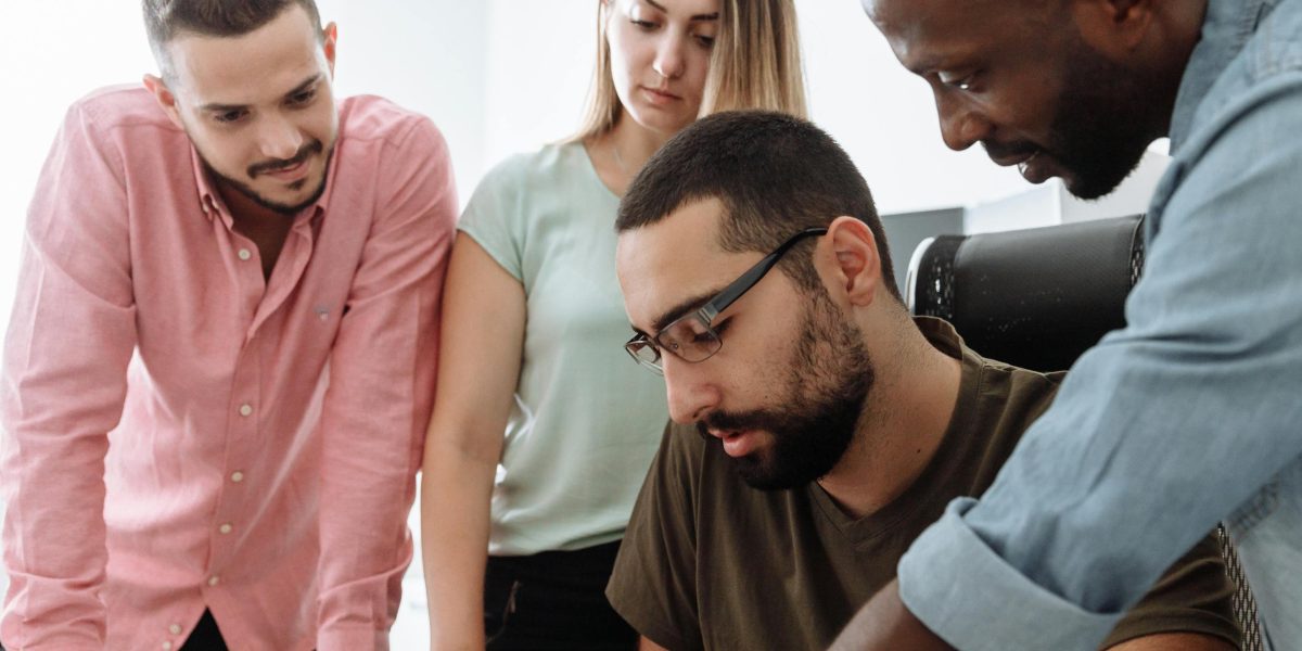 A team collaboratively addresses a project challenge, symbolizing the effort required to fix errors caused by AI hallucinations.