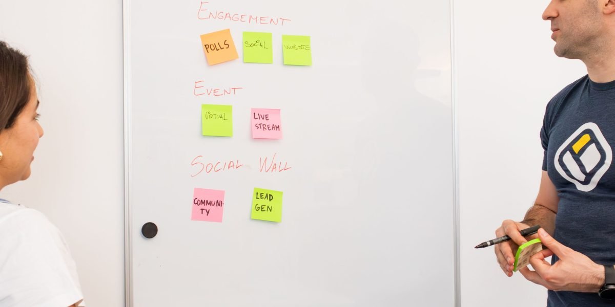 Colleagues collaborate at a whiteboard, actively working on strategies to mitigate AI risks and improve reliability.