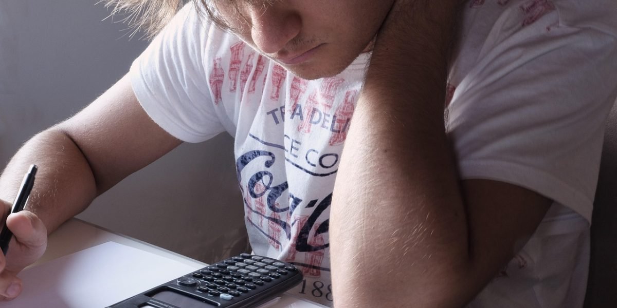 A developer intensely focused on solving a complex problem at their desk, illustrating the debugging process.