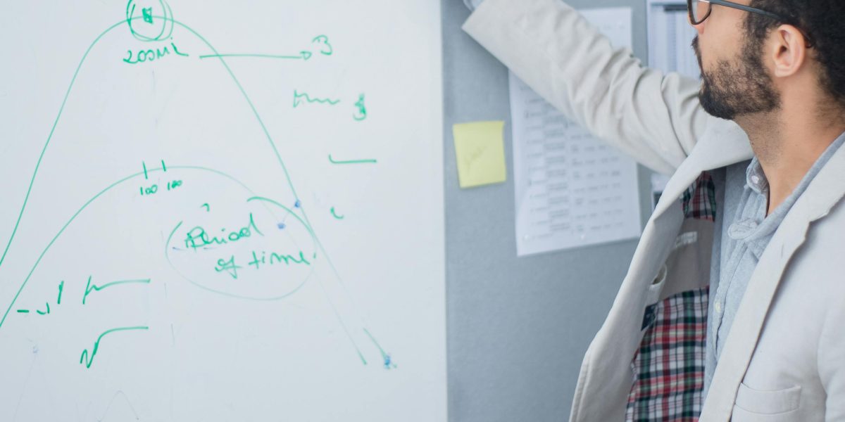 A professional outlining strategies on a whiteboard, emphasizing proactive planning for error prevention.