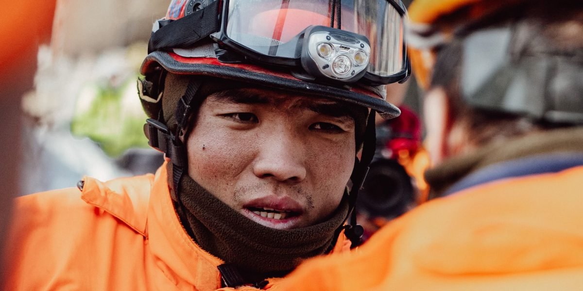 Emergency responders intently review a map, highlighting the critical need for accurate geospatial data in high-stakes situations.