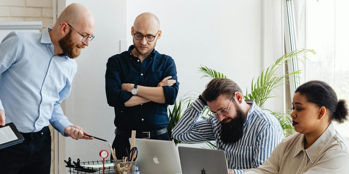 A diverse team collaborating around a whiteboard, discussing strategies for building ethical and trustworthy AI systems.