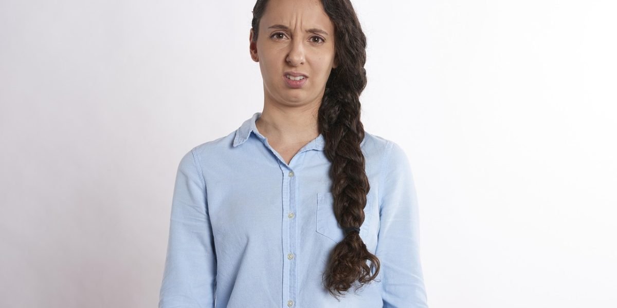 A person looking worried while checking their phone, representing declining user trust in AI technology due to performance issues.