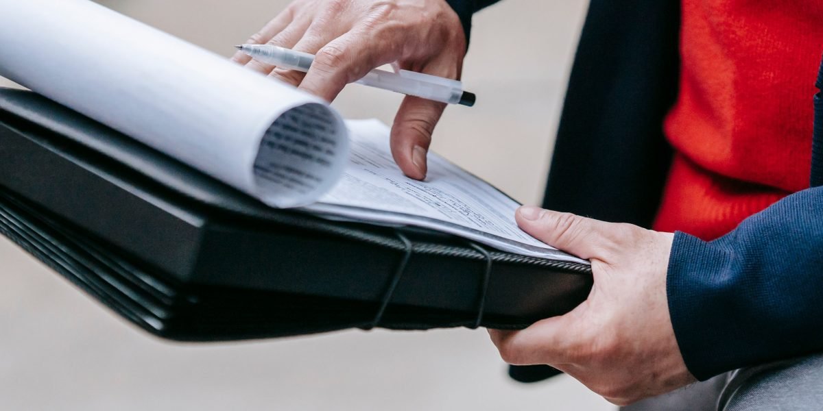 A focused professional meticulously reviews documents, symbolizing the critical human oversight needed in AI-powered systems.