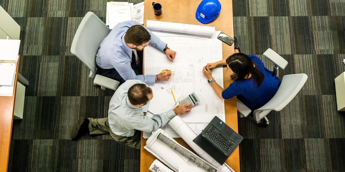 Executives in a business meeting engaged in a strategic discussion, emphasizing the critical importance of trust and reliability when integrating AI-generated assets into enterprise workflows.