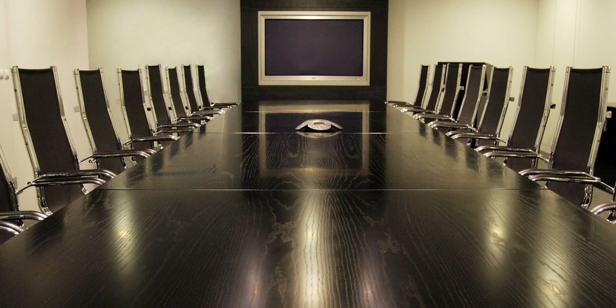 An executive expresses concern during a meeting, emphasizing the risks of unreliable AI outputs.
