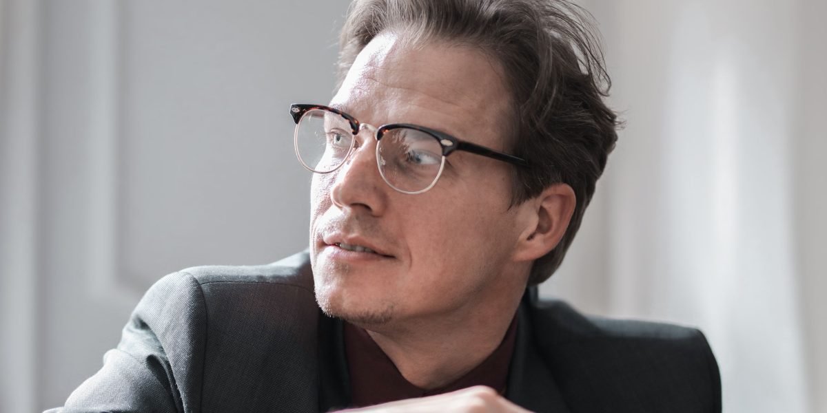 A business leader deep in thought, reflecting on the serious implications of trust and brand reputation.