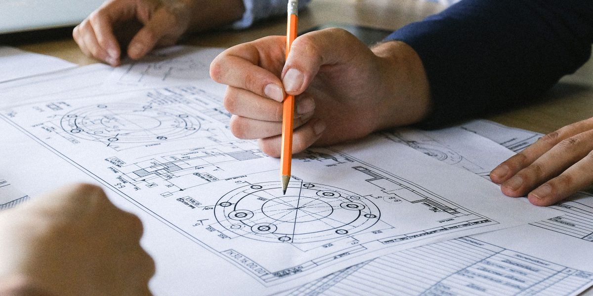 A person focused on a tablet, analyzing data or plans, representing the critical evaluation phase of AI tools.