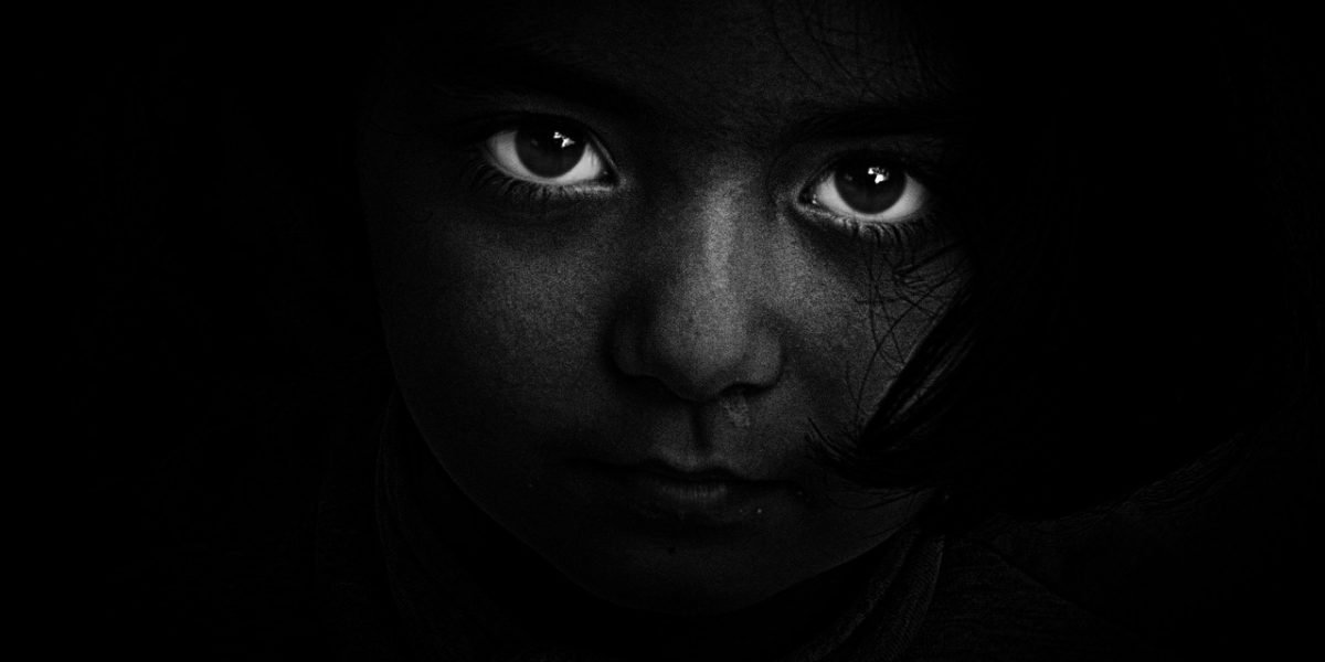 A person looks contemplative, pondering the reliability of information received, symbolizing the challenge of trusting AI outputs.